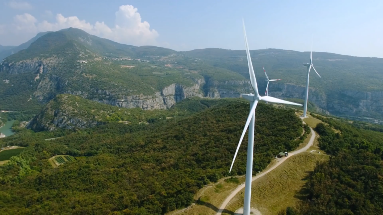 Windmills over a grassy landscape